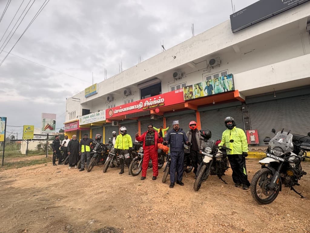 Riders and motorcycles gathered outside a storefront in Tamil Nadu