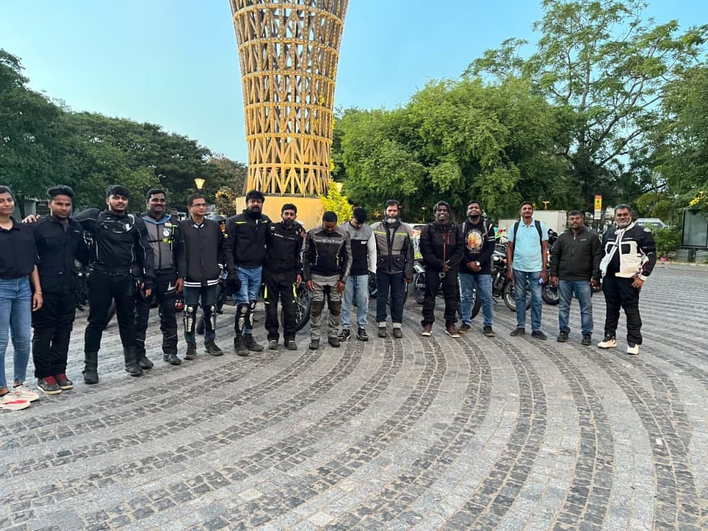 Riders assembled in a circle around a city landmark